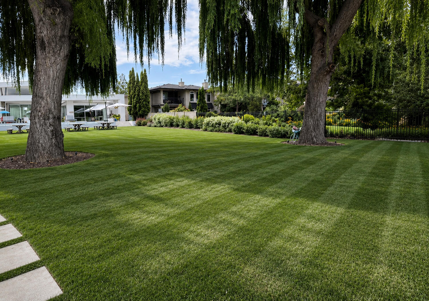 Freshly manicured lakeside lawn with clean mow lines, maintained by Clean-Cut Property Care